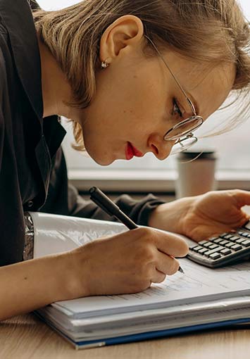 woman working on paper financial documents