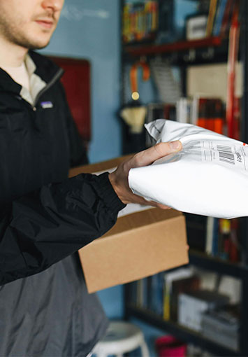 Person handling mail in a mail processing facility