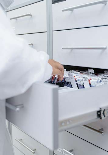 Medical Technician Using a Filing Cabinet At Work