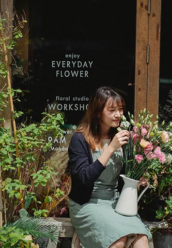 Seasonal business owner in front of their store