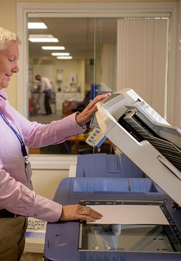 Man Scanning Documents in a Business Setting