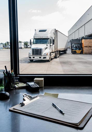Interior Shot of Logistics Company Desk With Truck Outside